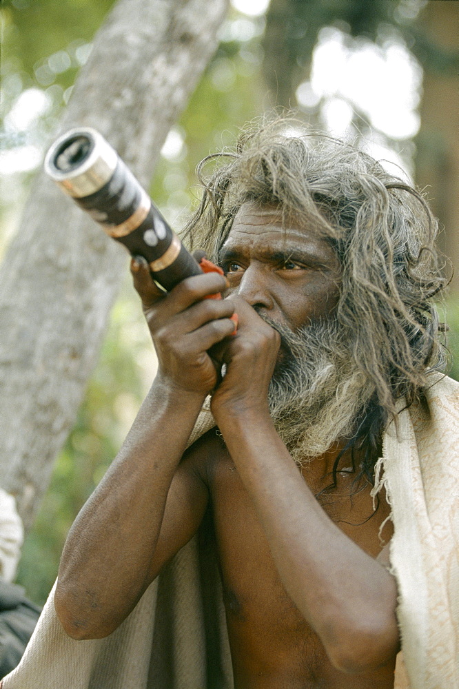 Sadhu smoking nirvana at pashupati nath temple, nepal 