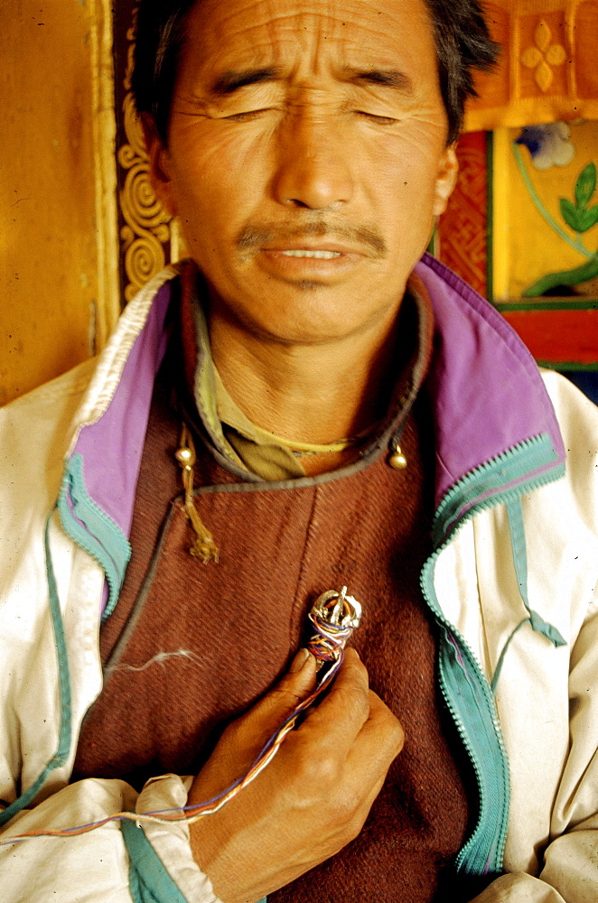 N month of november 7 days before full moon a sacred ceremony is held in various monasteries throughout himalayas by traditional healers known as amchis. They bring their precious herbs, minerals special animal glands to be blessed. A selected amount of herbs is placed in a copper vessel placed on monastery alter. 7 days amchis go through an elaborate potenization of these medicines through prayer other practices. Seen here is of amchis holding a dorje (sacred object used cutting through obscurations) which is lined from a vessel containing various herbs sitting on monastery alter to heart chakra. Chang tang nyee, ladakh, indi