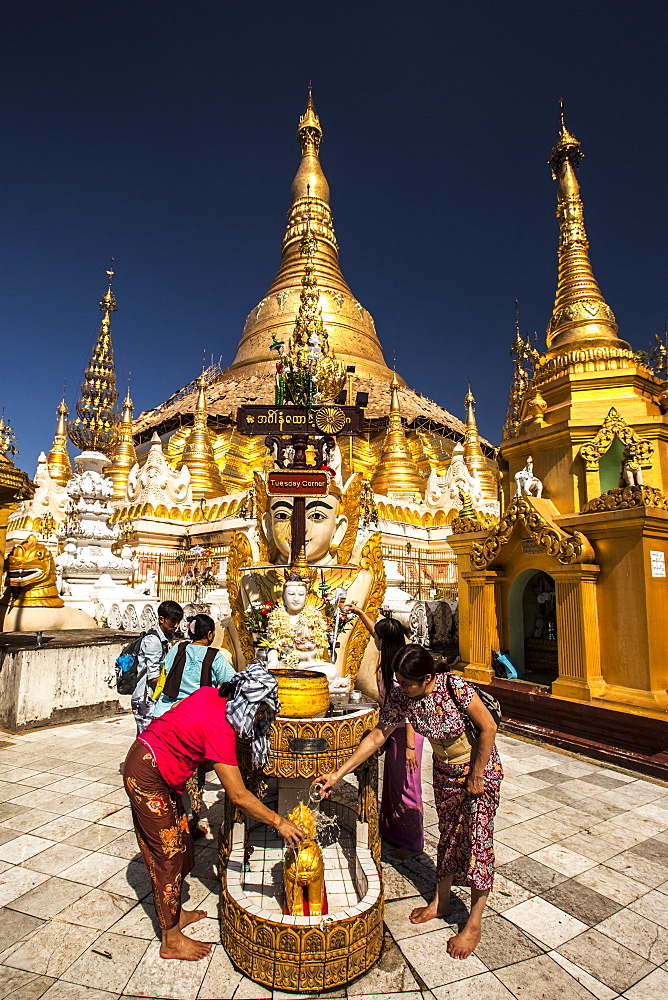 Water offering at Tuesday Corner statue, Shwedagon Paya, Yangon (Rangoon), Myanmar (Burma), Asia