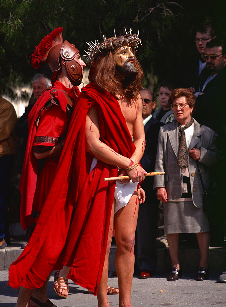 Masked figure of Christ in Maundy Thursday procession through streets, Marsala, Sicily, Italy, Europe