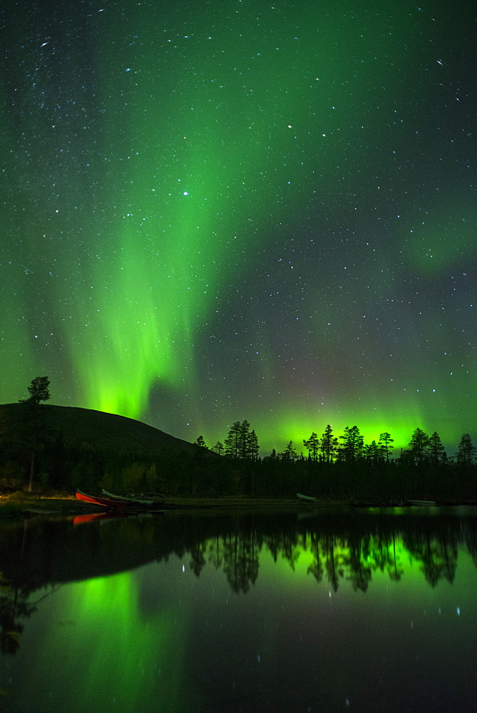 Aurora Borealis and stars over lake at night, Muonio, Lapland, Finland, Scandinavia, Europe