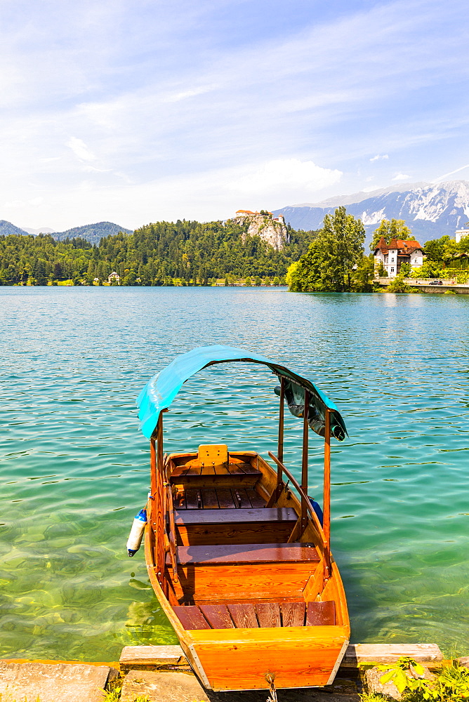 A boat on Lake Bled with Bled Castle in the background, Lake Bled, Slovenia, Europe