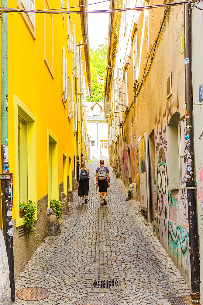 Couple walking in an alleyway in Ljubljana, Slovenia, Europe