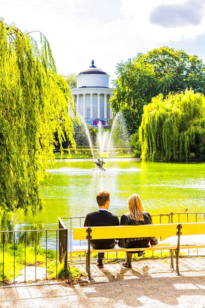 Couple sitting on a bench in Saxon Garden, Warsaw, Poland, Europe