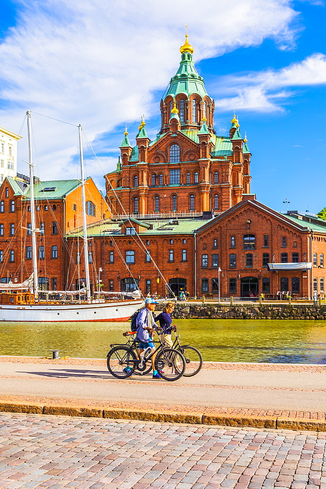 Uspenski Cathedral and cyclists by harbor in Helsinki, Finland, Europe