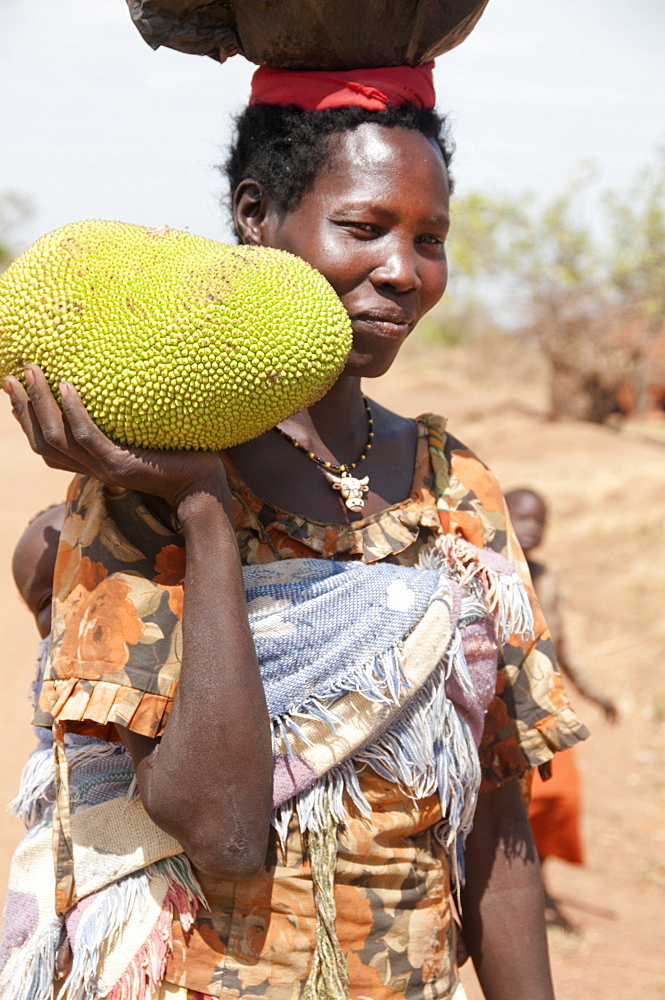 Woman holding a jack fruit, Lira, Uganda, Africa