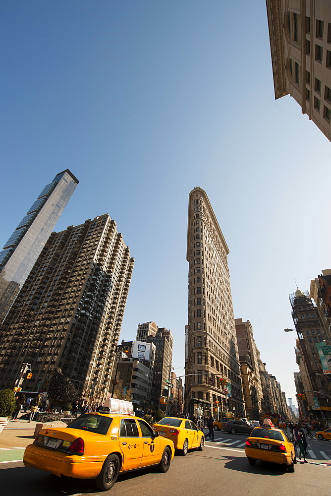 Flat Iron Building and yellow cabs at the intersection of 5th Avenue and Broadway, New York, United States of America, North America