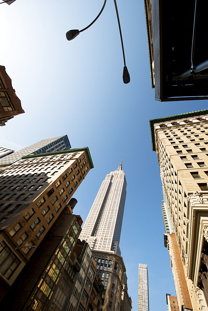 Looking up through skyscrapers at the Empire State, New York, United States of America, North America