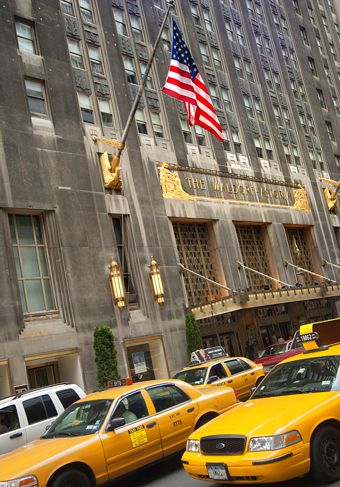 The Waldorf Astoria Hotel and yellow taxis, New York, United States of America, North America