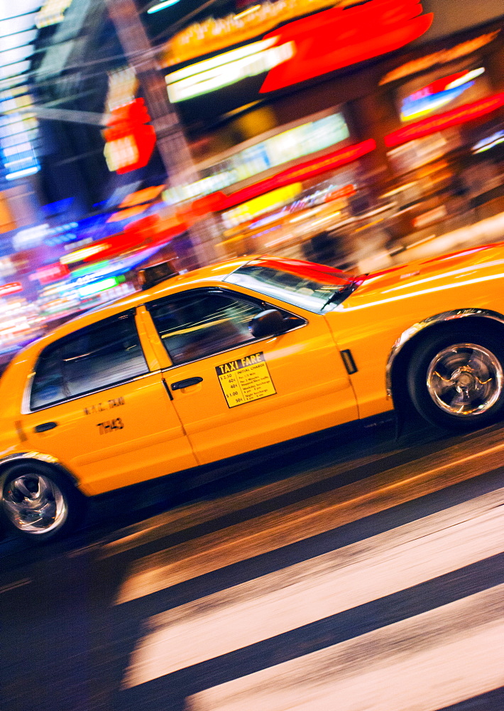 Traditional yellow taxi at night, New York City, United States of America, North America