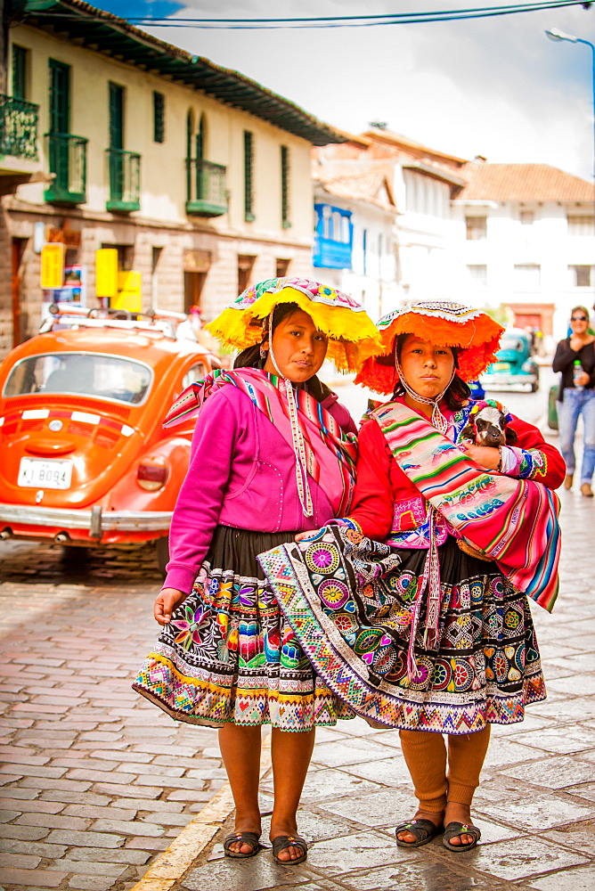 Two Cholita Peruvian girls and their lambs, Cusco, Peru, South America