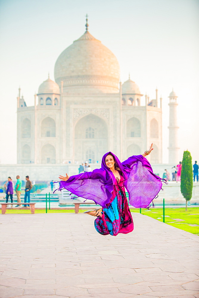 Laura Grier jumping at the Taj Mahal, UNESCO World Heritage Site, Agra, Uttar Pradesh, India, Asia