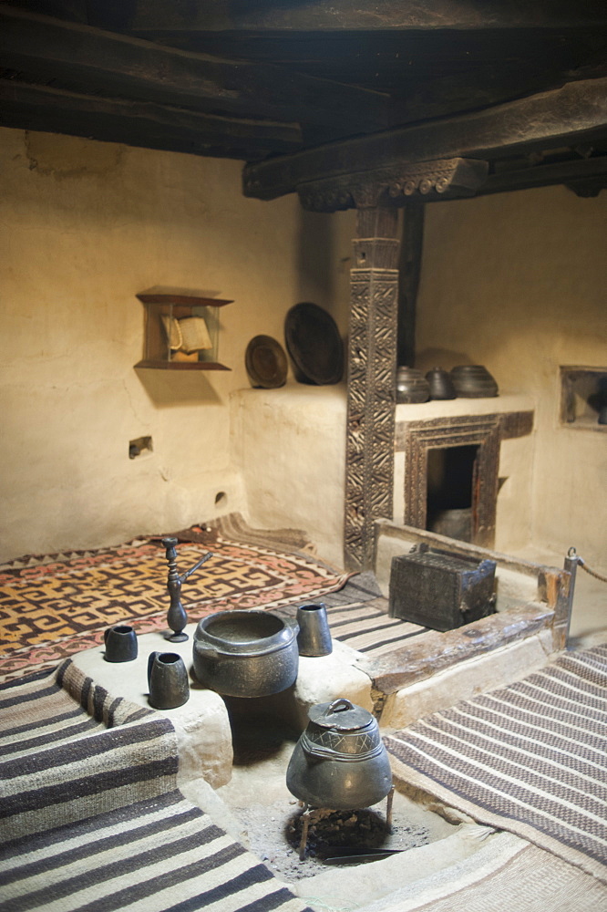 A ancient style kitchen with stone pots on display in a museum in the Hunza Valley, Gilgit-Baltistan, Pakistan, Asia