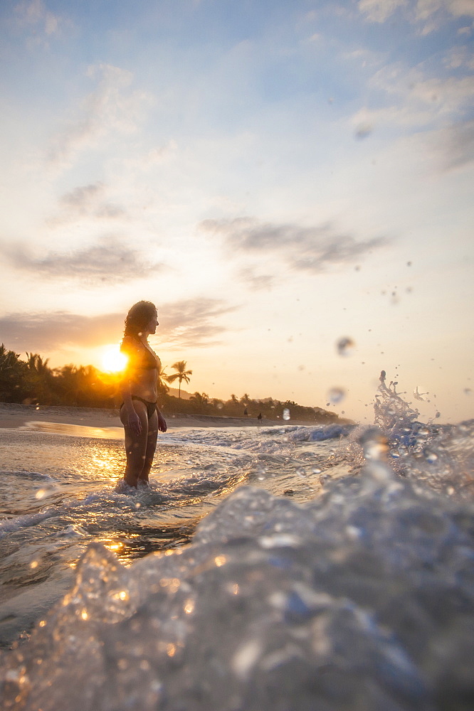 A girl plays in the waves at Palomino on the Caribbean coast of Colombia, South America