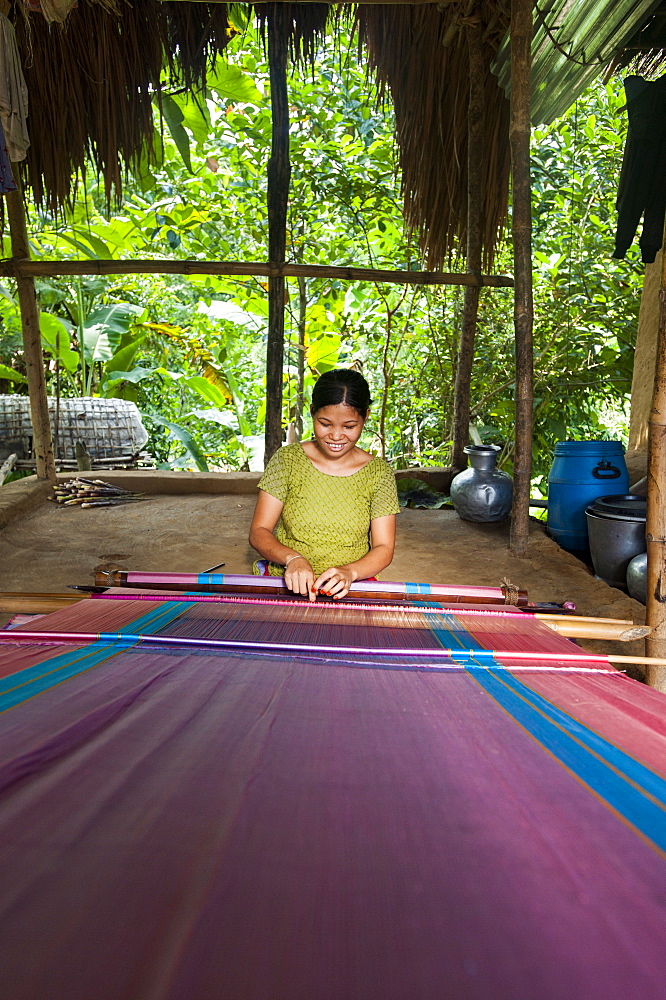 A woman weaves traditional fabric using a hand loom, Chittagong Hill Tracts, Bangladesh, Asia