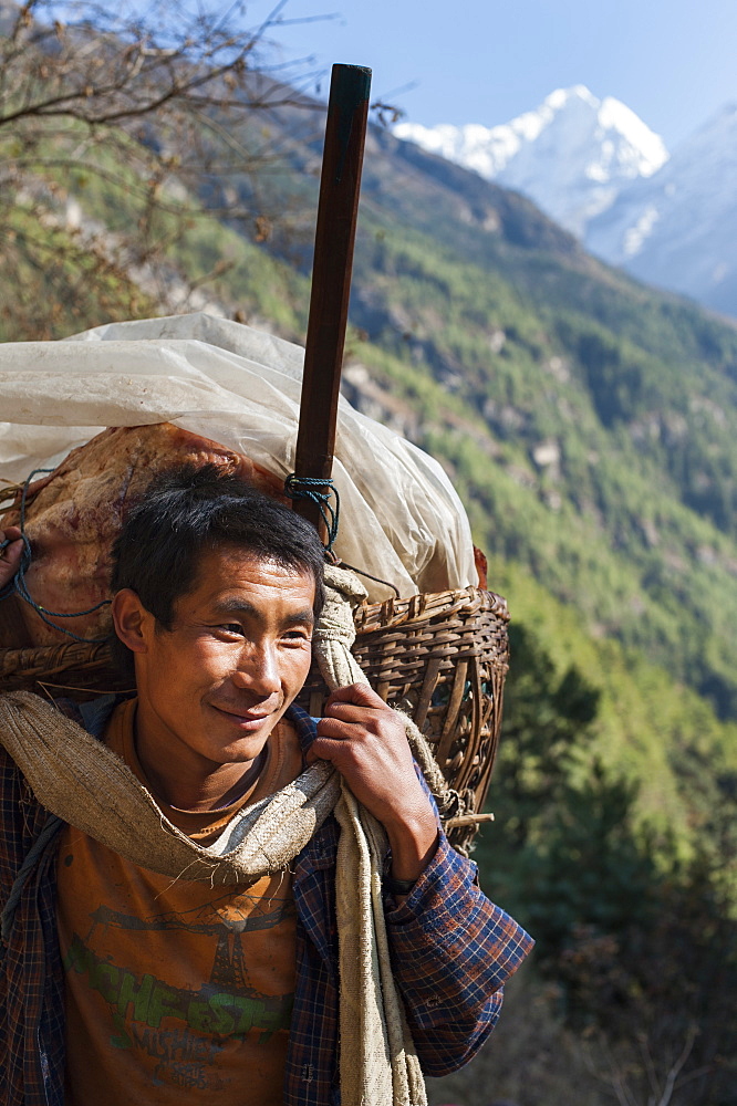 A porter makes his daily journey from Lukla to Namche, Himalayas, Nepal, Asia