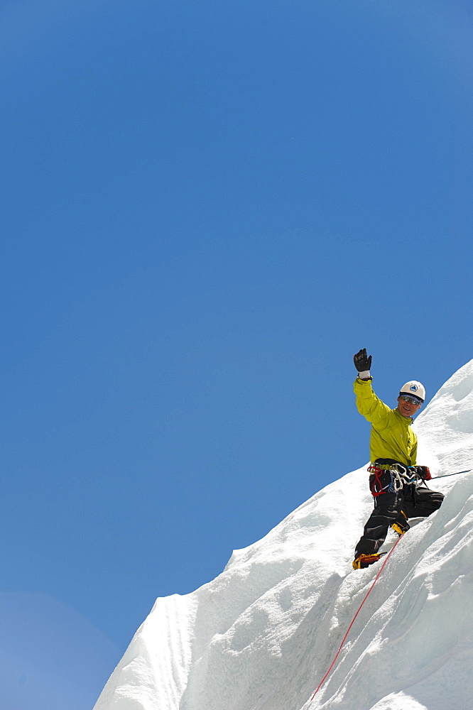 A climber practises on an ice wall in preparation for climbing Everest, Khumbu Region, Nepal, Asia