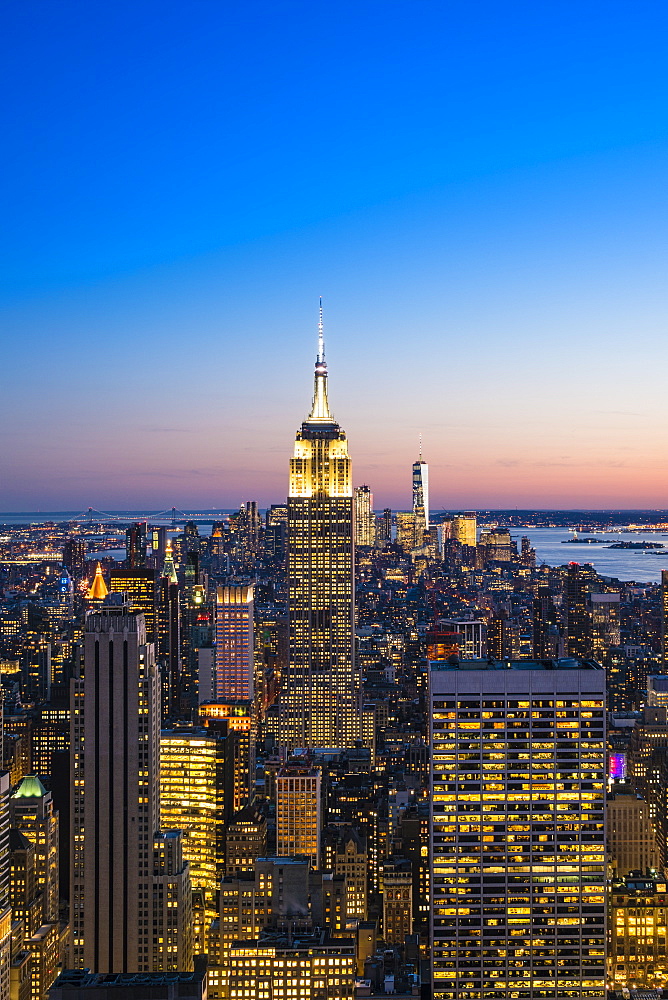 Manhattan skyline and Empire State Building at dusk, New York City, United States of America, North America