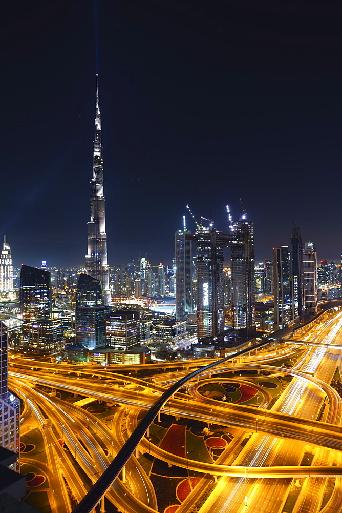 Dubai skyline and Sheikh Zayed Road Interchange by night, Dubai, United Arab Emirates, Middle East