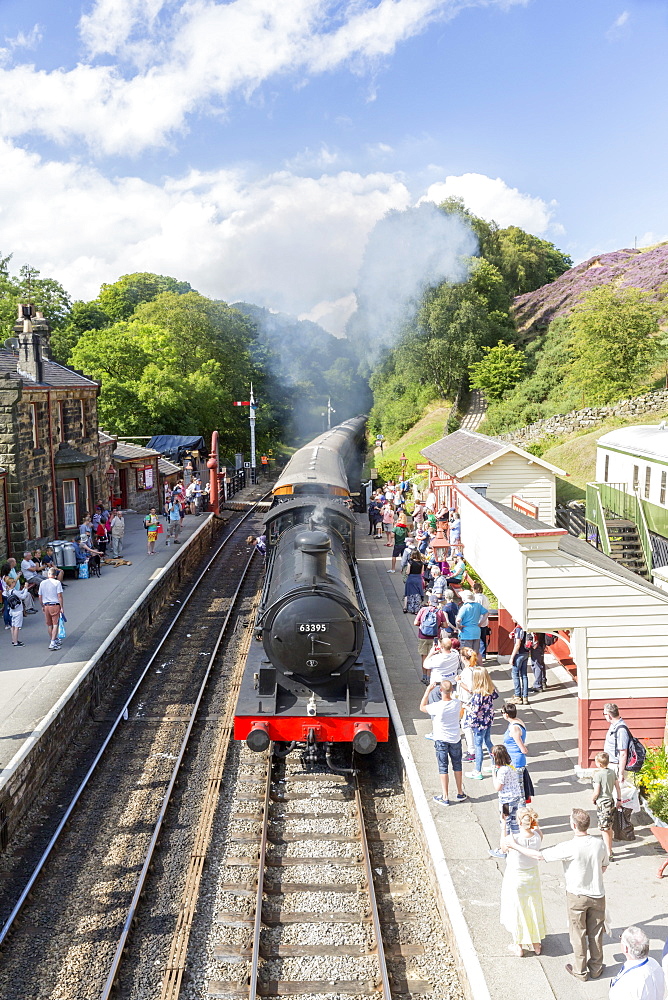 Goathland station and a steam locomotive pulling in from Grosmont, on the North Yorkshire Moors Steam Railway, Goathland, Yorkshire, England, United Kingdom, Europe