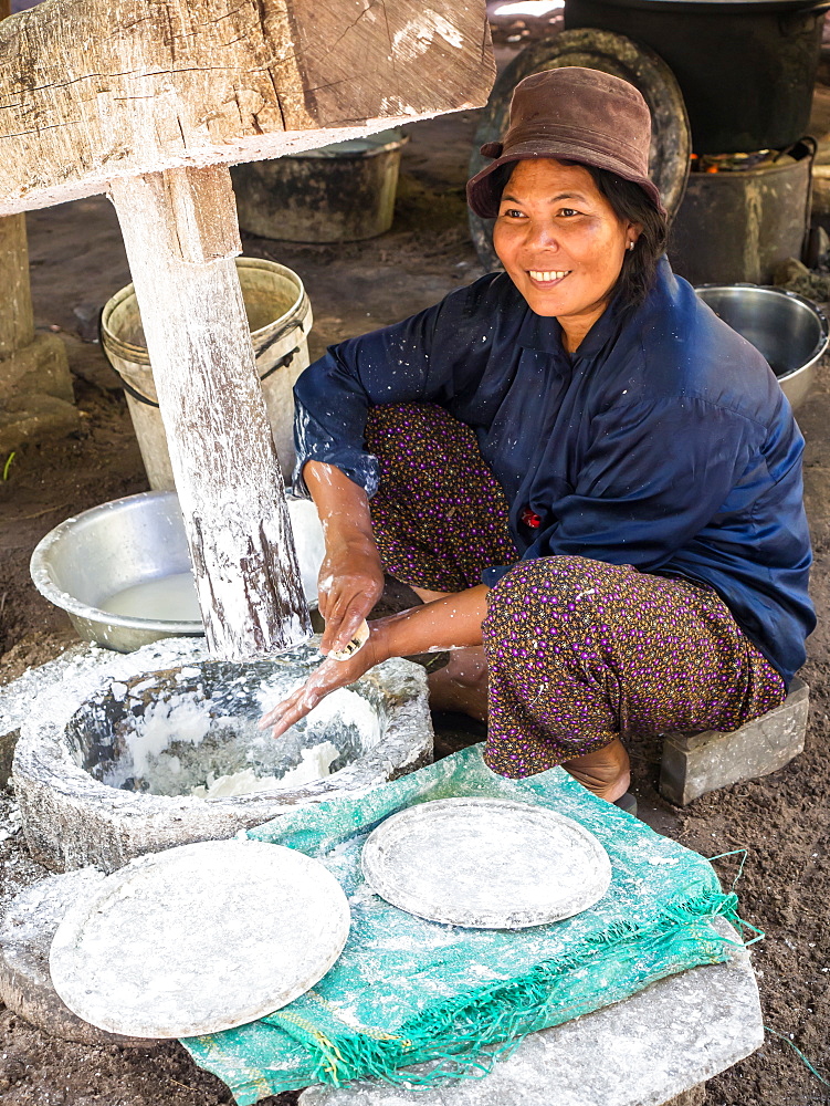 Woman using a large wooden press to make dough for noodles, village near Siem Reap, Cambodia, Indochina, Southeast Asia, Asia