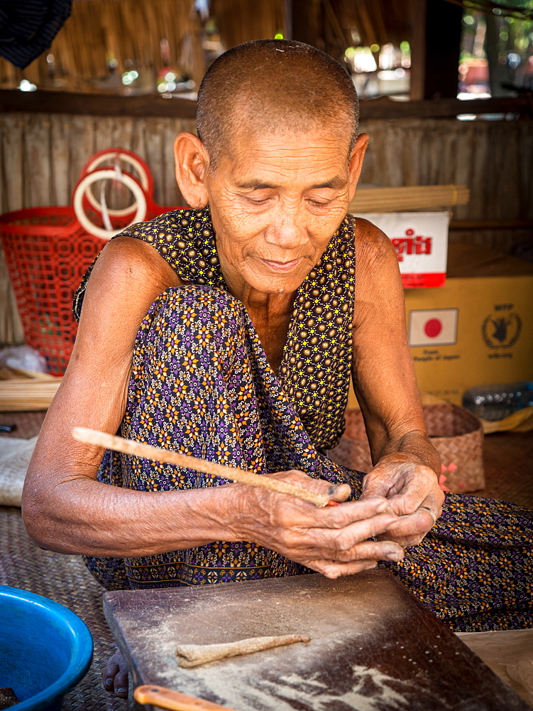 Old woman making incense, village home near Siem Reap, Cambodia, Indochina, Southeast Asia, Asia