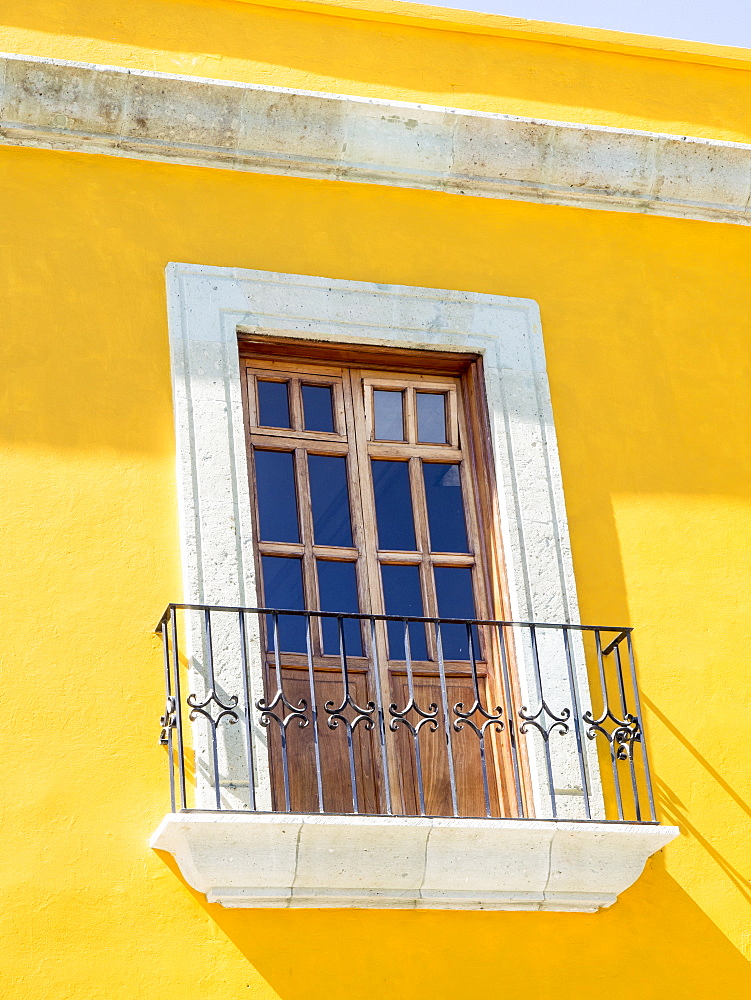 White window of yellow house, Oaxaca, Mexico, North America