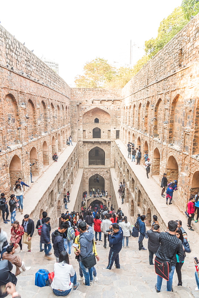 Groups of people at Agrasen ki Baoli, a historical step well on Hailey Road near Connaught Place, New Delhi, India, Asia