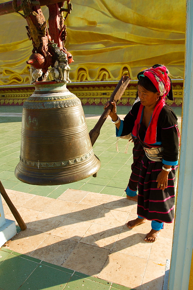 Buddhist bell and devotee, Bagan (Pagan), Myanmar (Burma), Asia