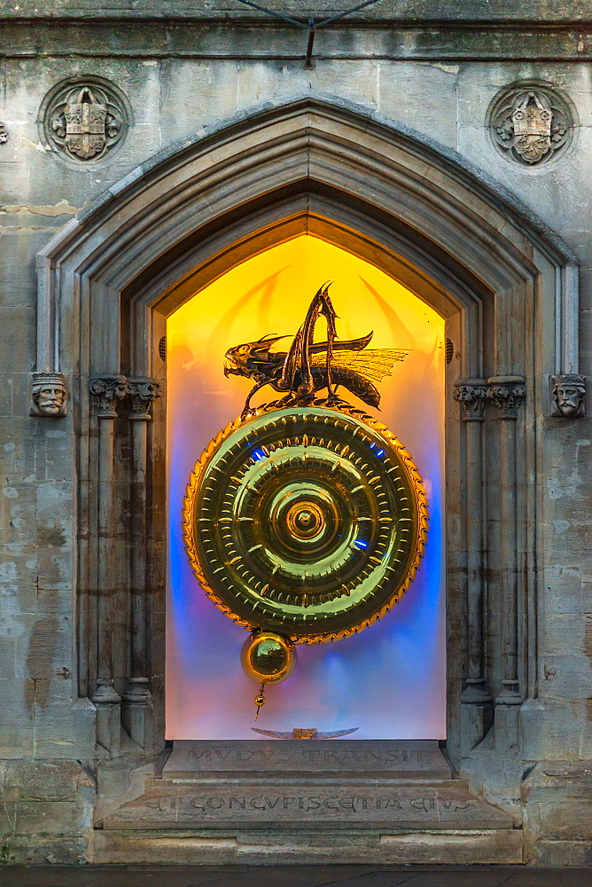 Night time view of the illuminated Corpus Christi Clock with Chronophage (Time Eater), Cambridge, Cambridgeshire, England, United Kingdom, Europe