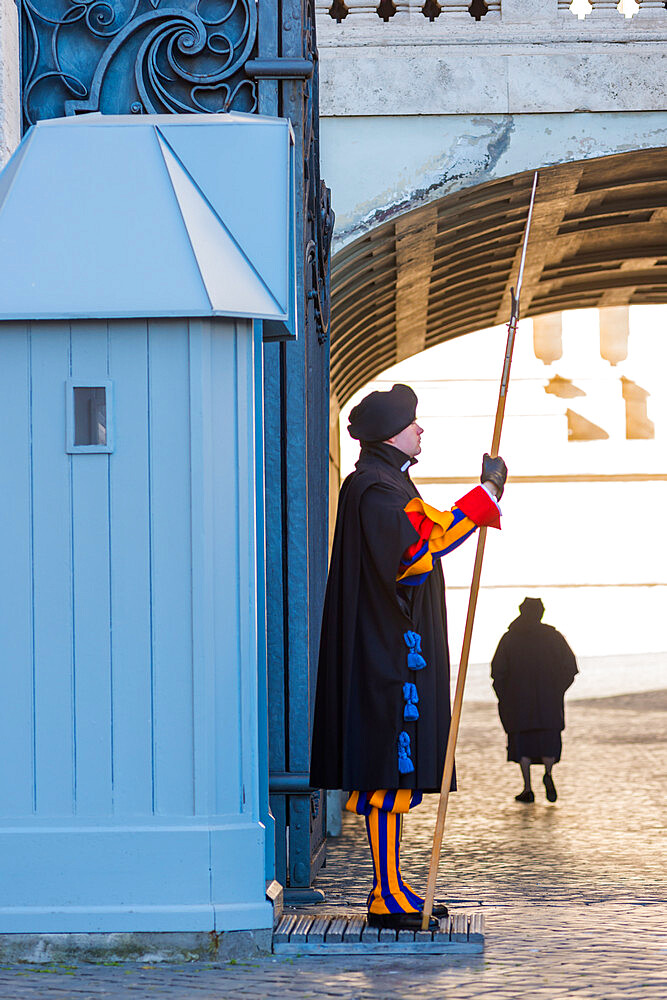 A Pontifical Swiss guard in ceremonial uniform at St. Peter's Basilica, Vatican City, Rome, Lazio, Italy, Europe