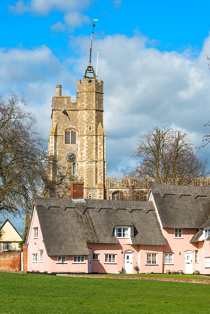 The village green in Cavendish with the medieval St. Mary church tower and traditional pink thatched cottages, Cavendish, Suffolk, England, United Kingdom, Europe