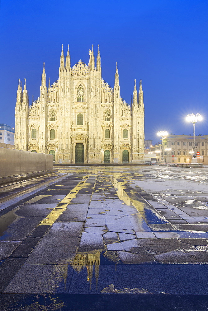 Milan Cathedral reflected in a puddle after a snowfall at twilight, Milan, Lombardy, Northern Italy, Italy, Europe