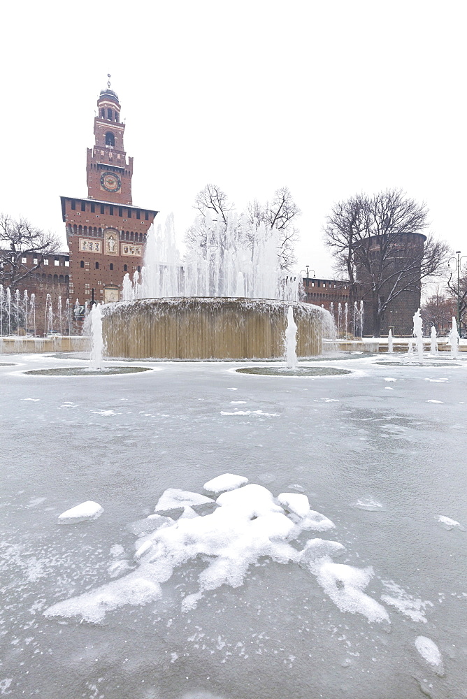 A iced fountain and Sforzesco Castle after a snowfall, Milan, Lombardy, Northern Italy, Italy, Europe