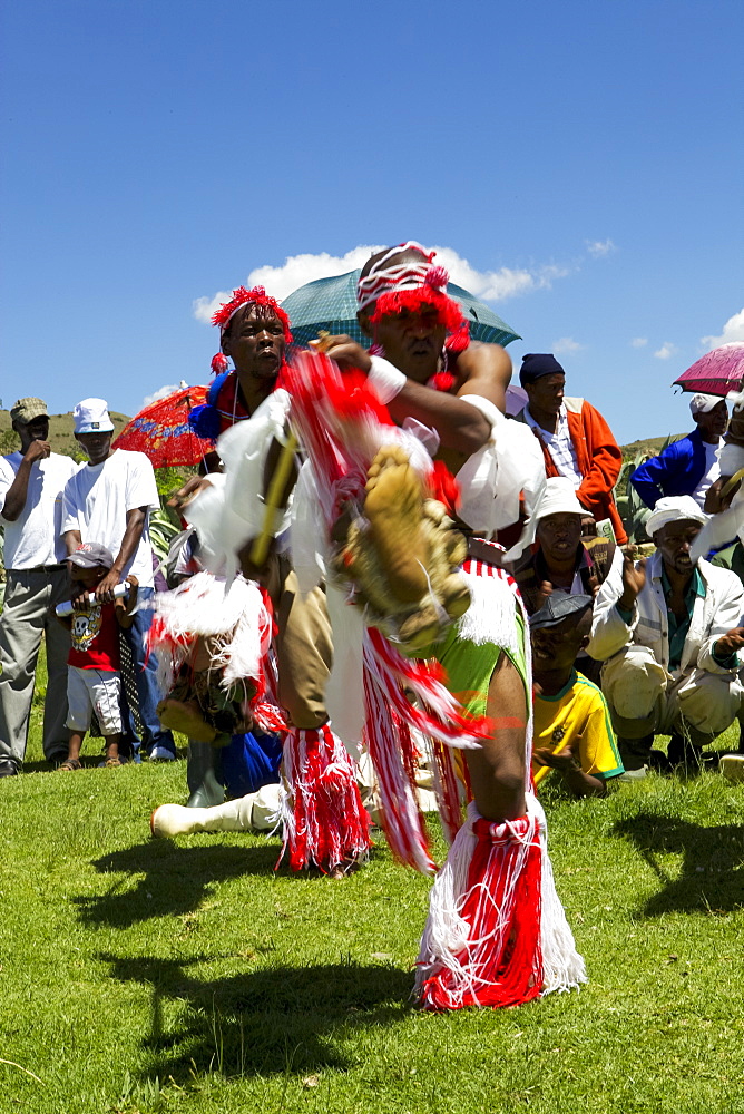 Traditional dancers entertain the crowds at one of Send a Cow's passing on ceremonies, Lesotho, Africa