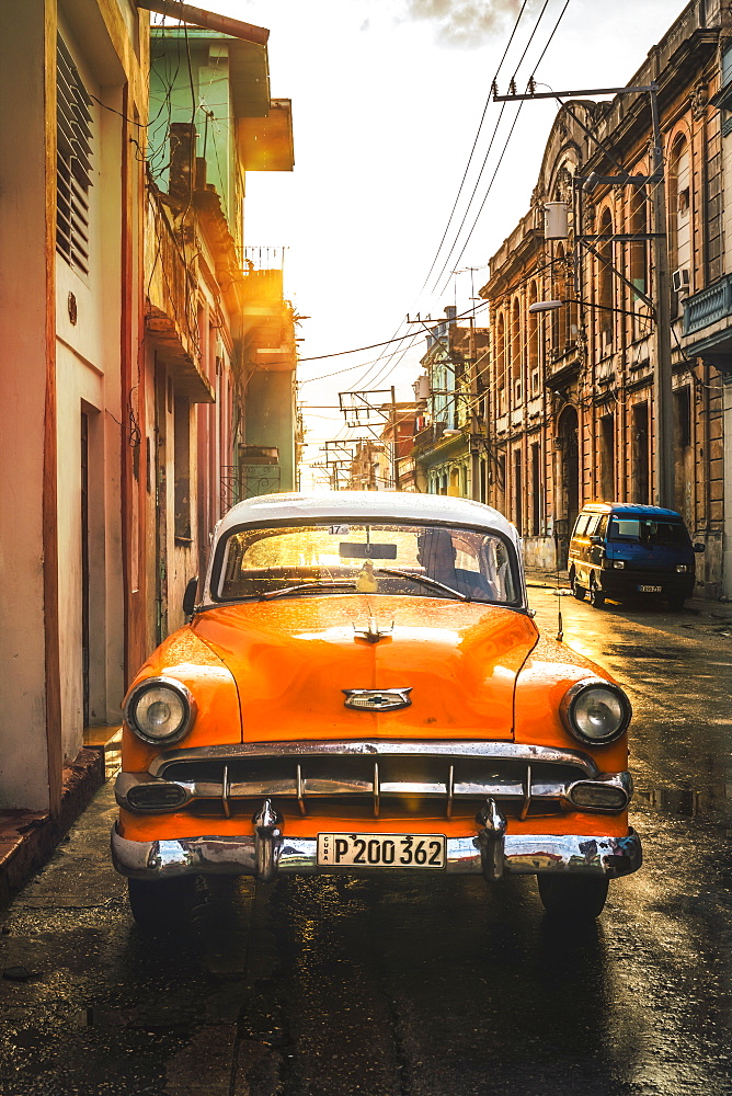 Orange American vintage car at sunset, La Habana (Havana), Cuba, West Indies, Caribbean, Central America