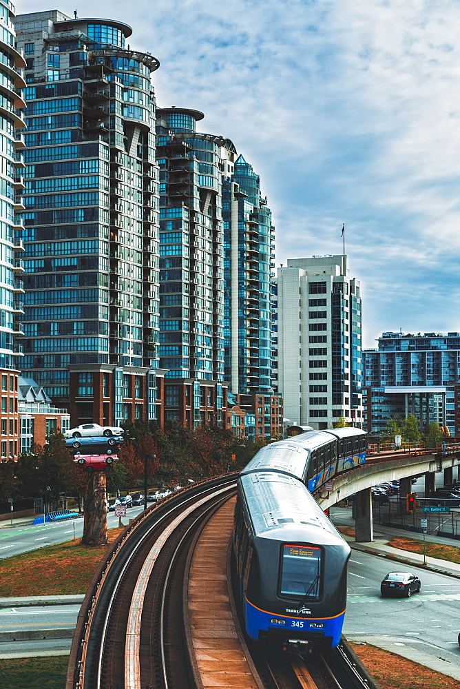 Sky Train metro, apartment buildings and Cars stacked as modern art exhibition, Vancouver, Canada, British Columbia, North America