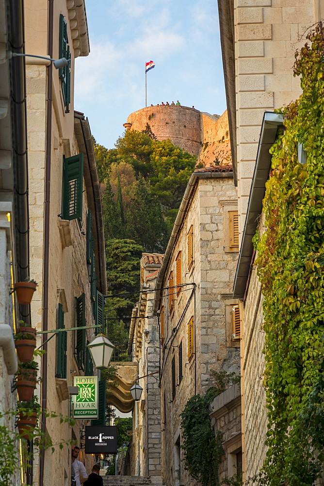 View from the old town of Hvar to the Spanish Fortress at sunset, Hvar, Croatia, Europe