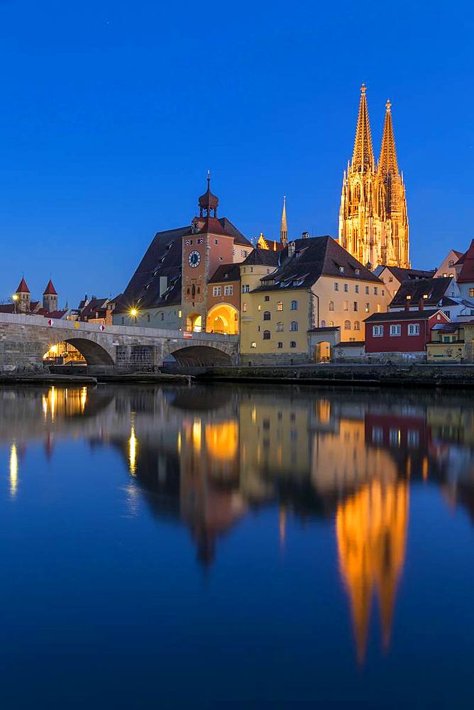 View to the Cathedral of St. Peter, the Stone Bridge and the Bridge Tower at dusk, Regensburg, Bavaria, Germany, Europe