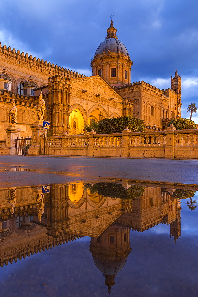 The illuminated Palermo Cathedral (UNESCO World Heritage Site) reflected in a puddle, Palermo, Sicily, Italy, Europe