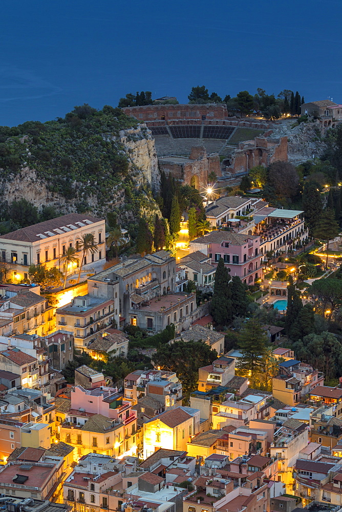 View down to the city centre and the ancient Greek Theatre at dusk, Taormina, Sicily, Italy, Europe