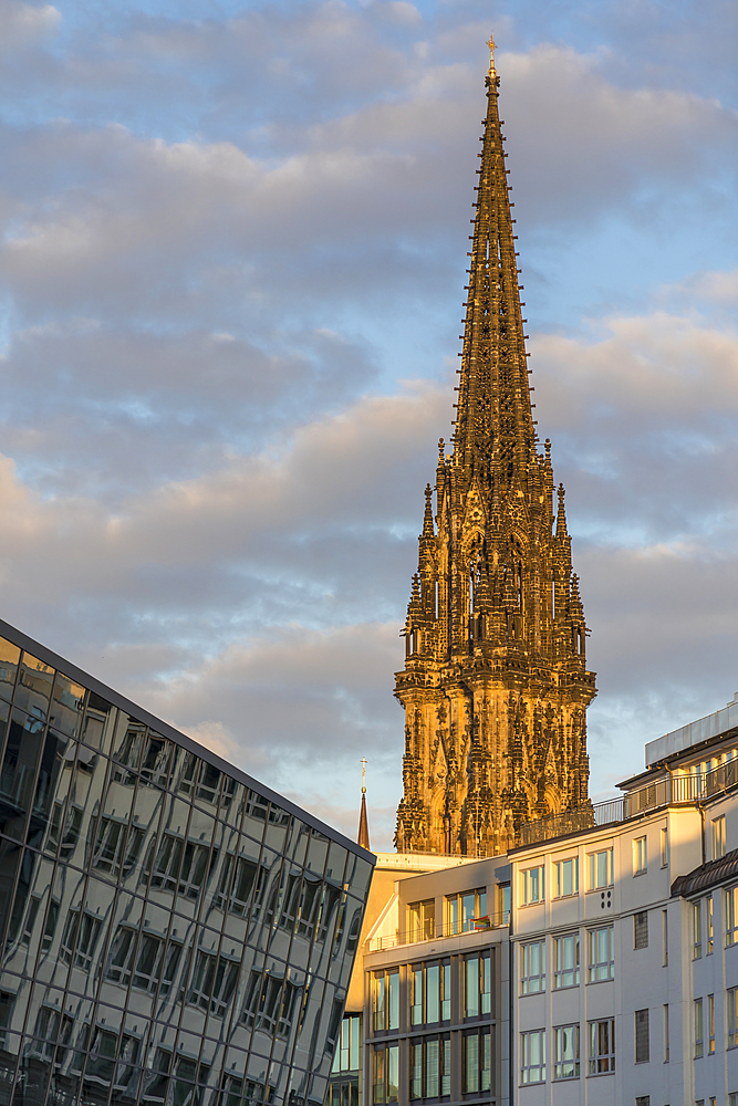 St. Nikolai Memorial seen from the Alsterfleet near Stadthausbruecke at last sunlight, Hamburg, Germany, Europe