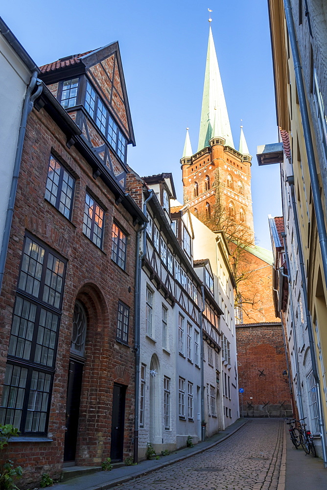 Small lane in the old town of Lubeck with view to the St. Petri Church, Lubeck, Schleswig-Holstein, Germany, Europe