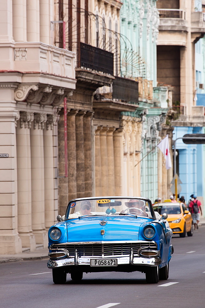 Blue convertible vintage taxi driving along Paseo de Marti in Havana, Cuba, West Indies, Caribbean, Central America