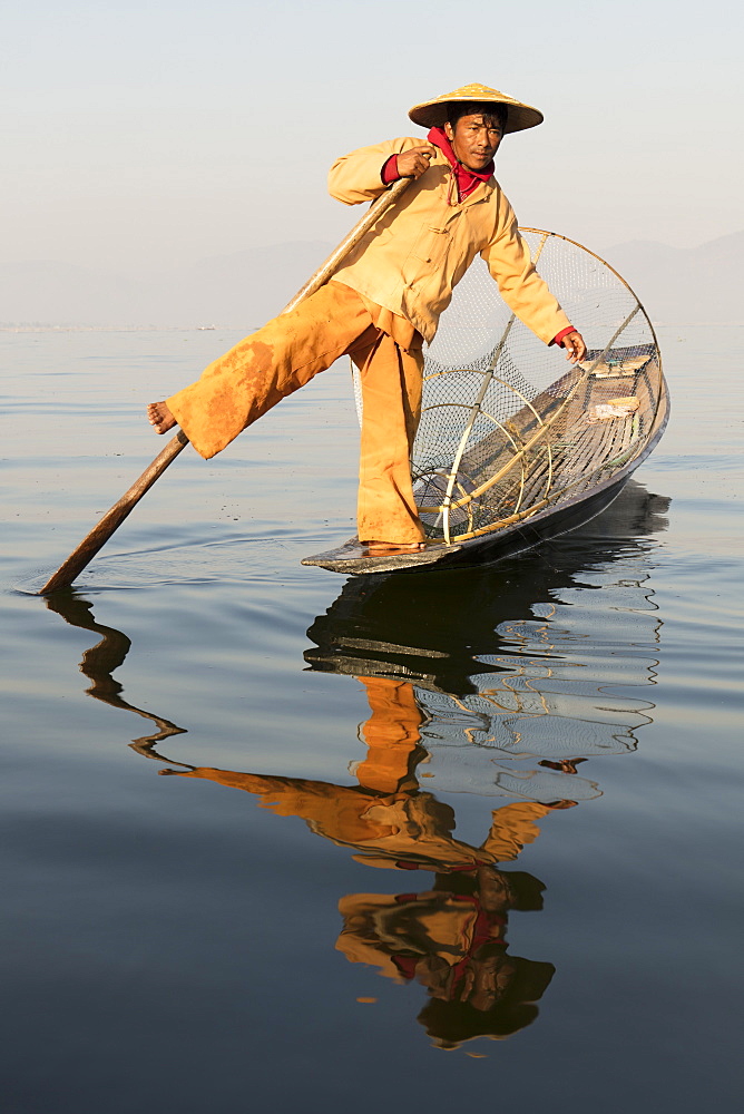 A fisherman rowing with one leg on Inle Lake, Shan State, Myanmar (Burma), Asia