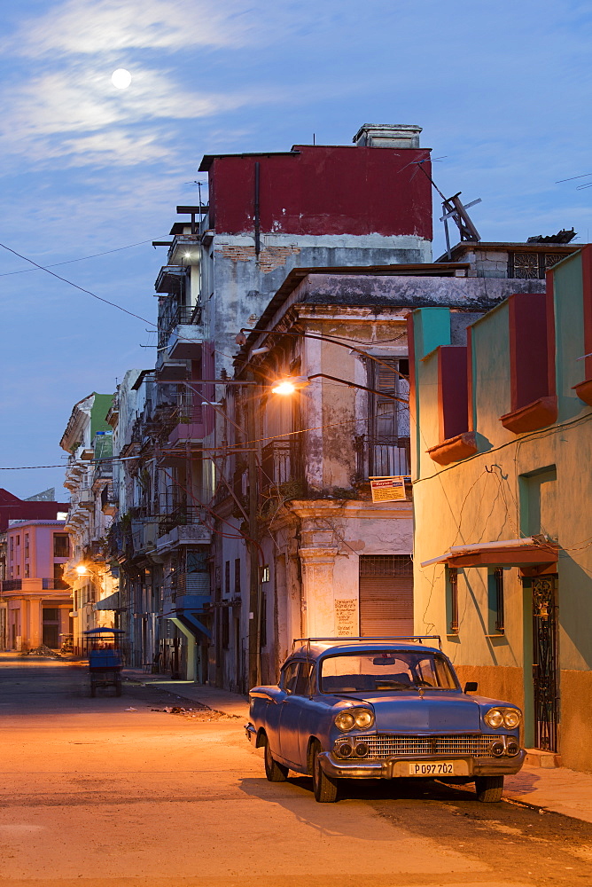 A blue vintage American car parked on a street in the early morning in Havana, Cuba, West Indies, Caribbean, Central America