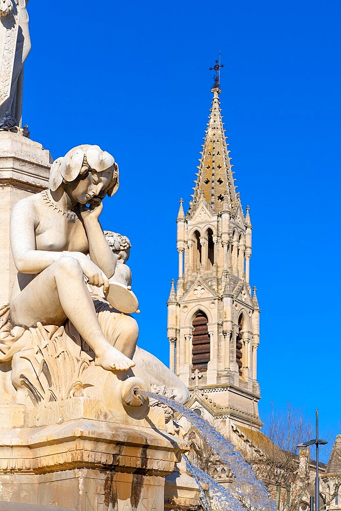 The Pradier Fountain with Saint Perpetue Church in background, Nimes, Gard, Occitania, France, Europe