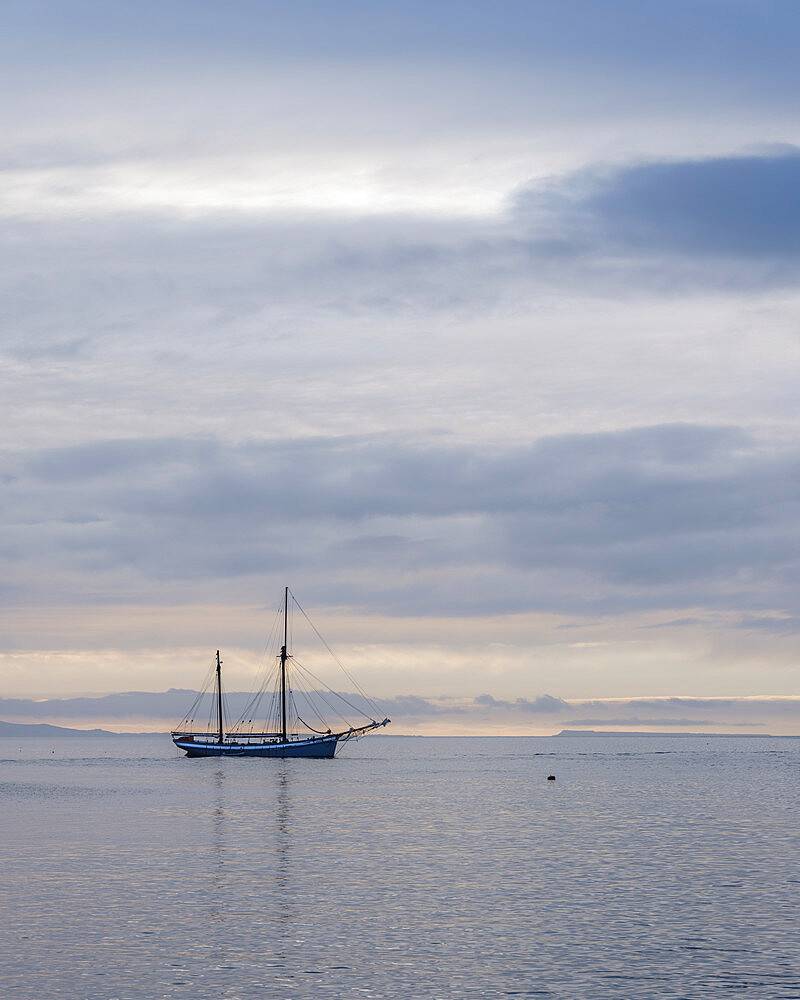 Yacht anchored off The Cobb in Lyme Regis, Dorset, England, United Kingdom, Europe