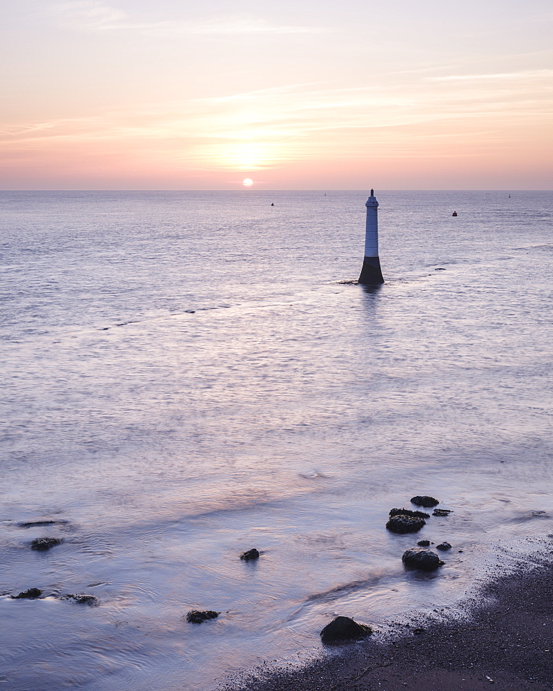 Sunrise across Torbay with the Navigation mark at the entrance to the River Teign, viewed from Shaldon, Devon, England, United Kingdom, Europe