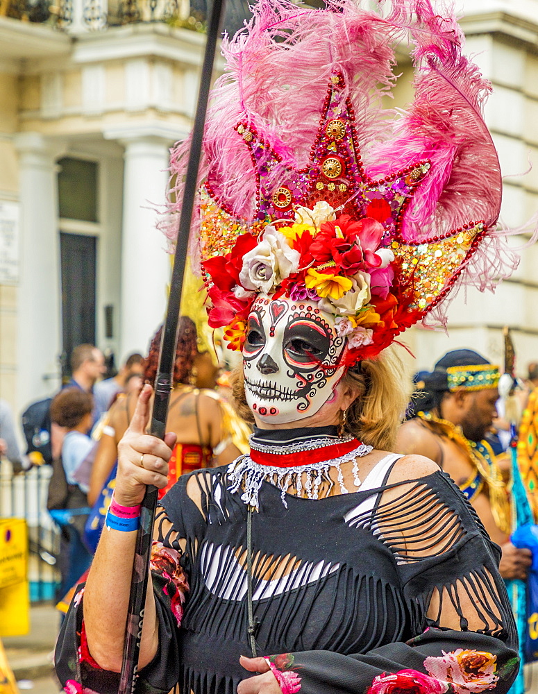 A colourfully dressed participant taking part in the Notting Hill Carnival, London, England, United Kingdom, Europe